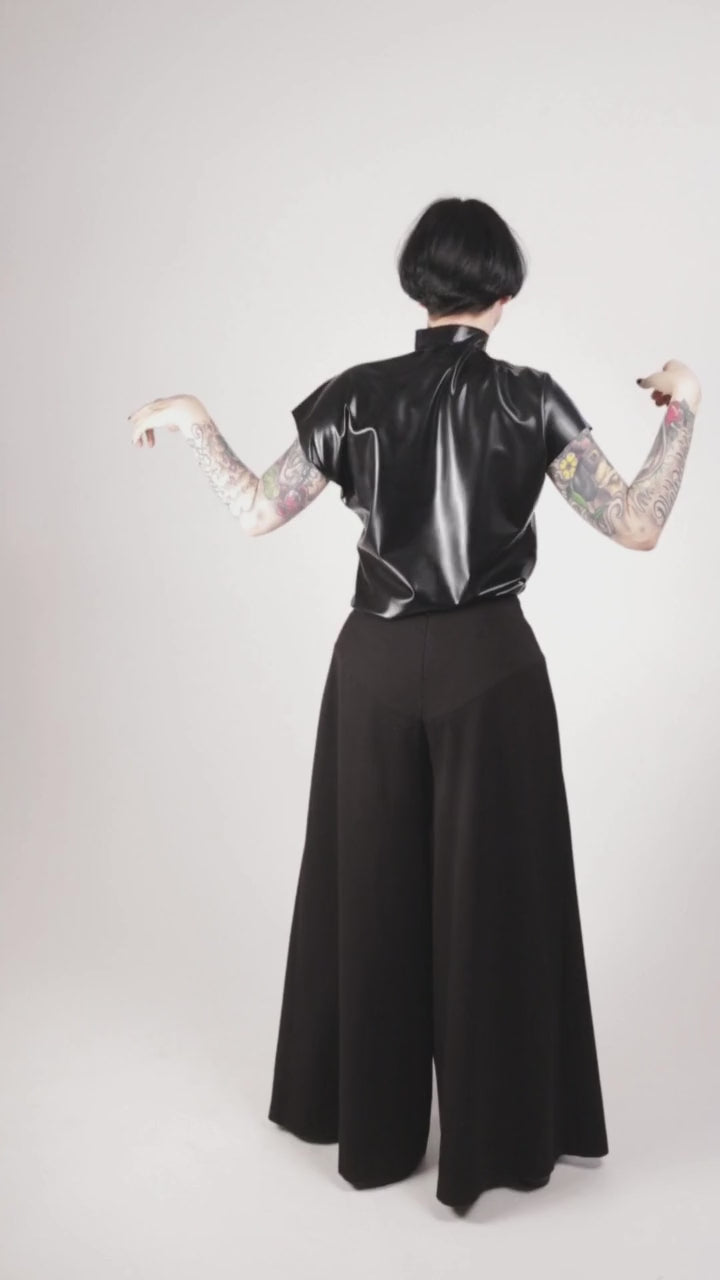 Anja von Abels performing some awesome chic dance moves in her black latex loose sleeveless top