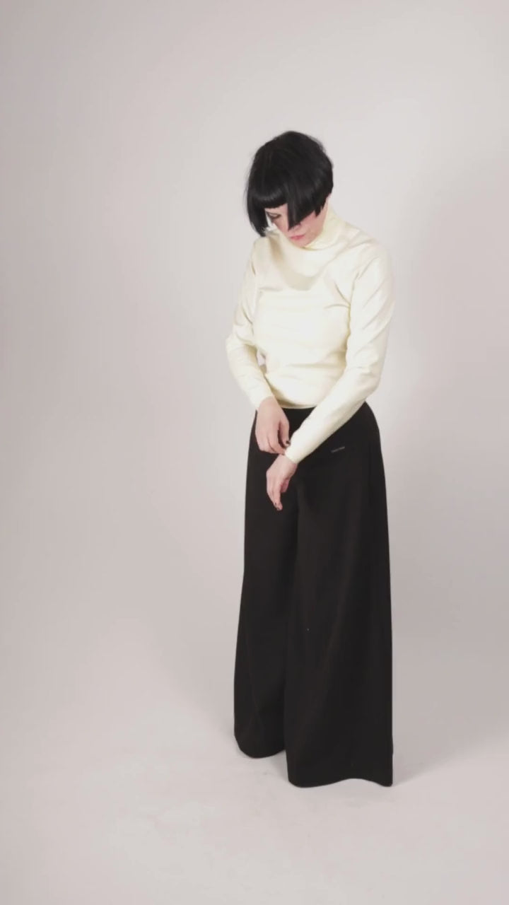 Anja von Abels wiggling into her white latex turtleneck top and enjoying the touch and feel of the material