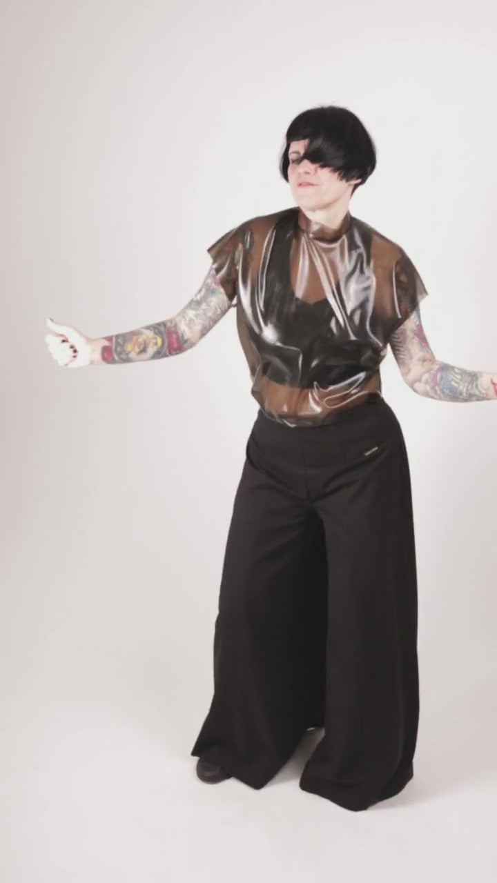 Anja von Abels dancing in her transparent black latex sleeveless top and her black sailor pants.