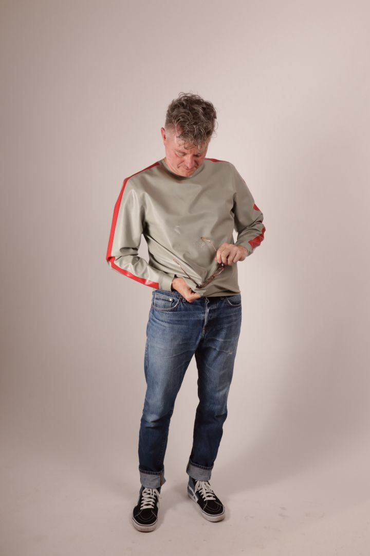 Fabian trying to to rub his glasses clean on his grey latex sweater. Nice try.