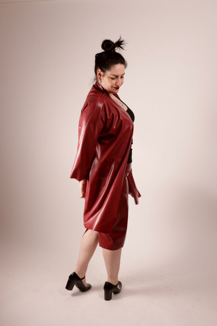 our model sadic sadie in our bordeaux latex fashion kimono and matching pencil skirt, shot from the side in the middle of a little spin to let the kimono fly.