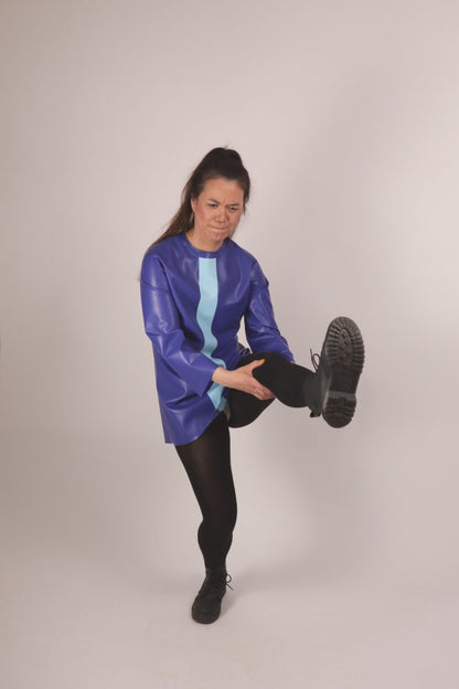christina doing a yoga position with high body tension in our blue latex 60s minidress