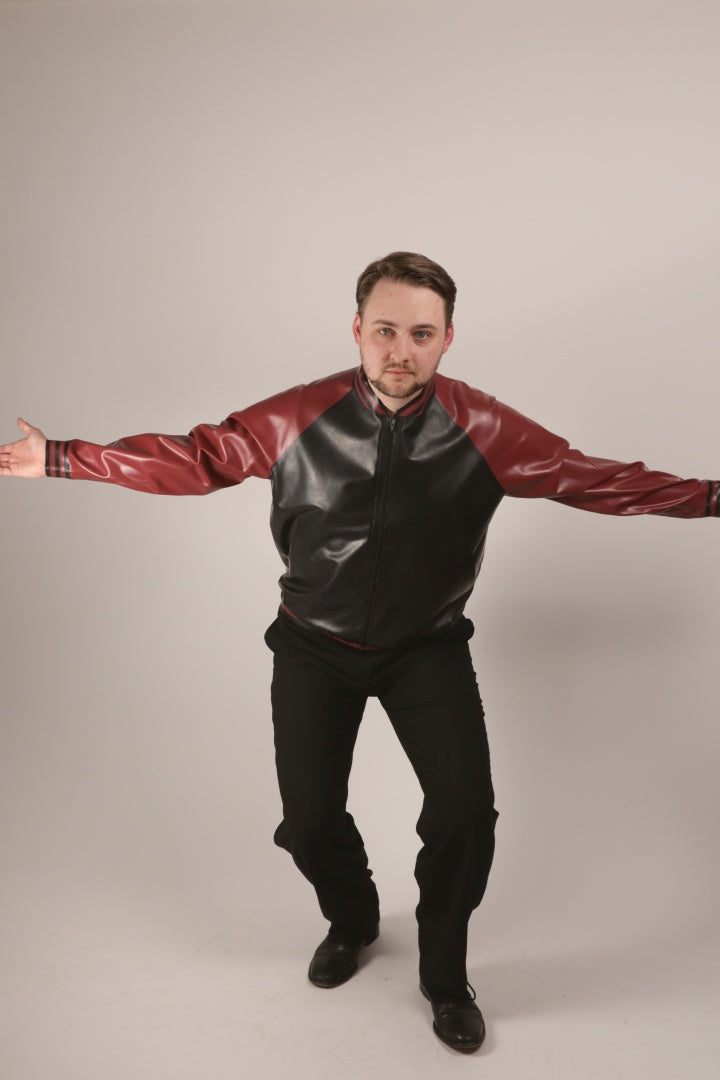 Total shot of Paul in our latex varsity jacket doing a tadaaa move into the camera.