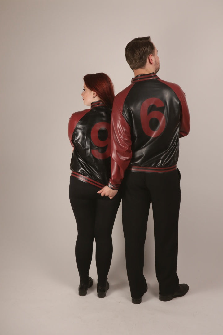 Rear view of Sarah and Paul in their matching TARZA & JANE latex college jackets with back numbers.