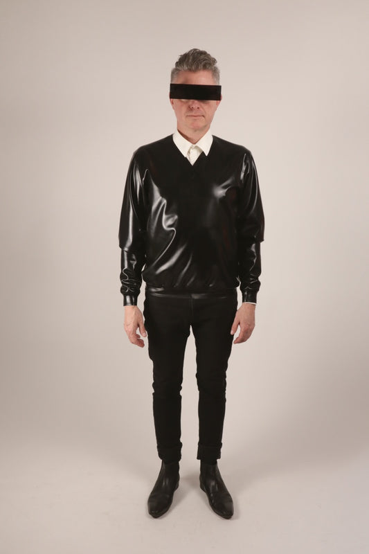 Front view of Fabian wearing a black V-neck latex sweater over a white dress shirt. And his new black incognito glasses.