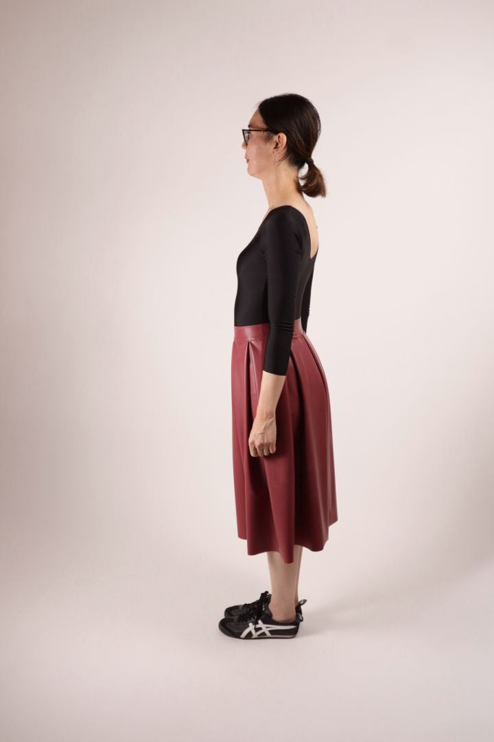 Side view of our model Hani in our TARZA & JANE bordeaux red demi latex skirt