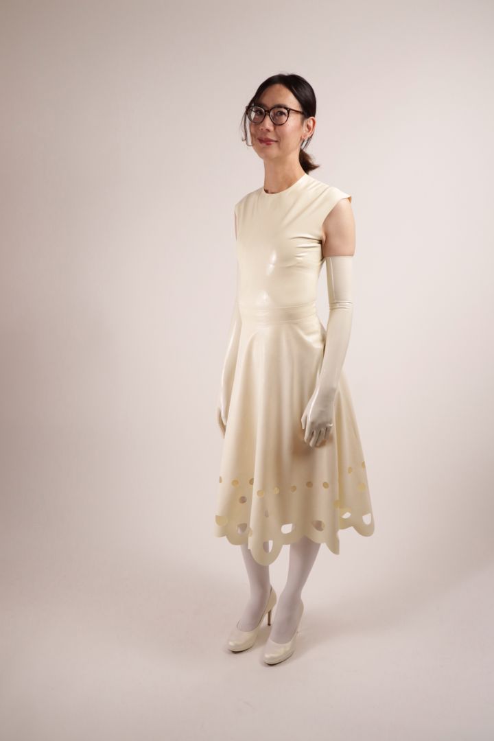Hani smiling in our white latex lacey wedding dress.