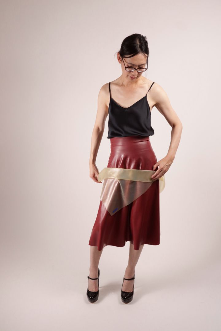 Our model Hani folding the TARZA & JANE latex scarf.