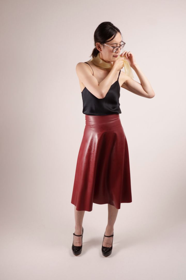 Hani draping the TARZA & JANE transparent latex scarf around her neck.