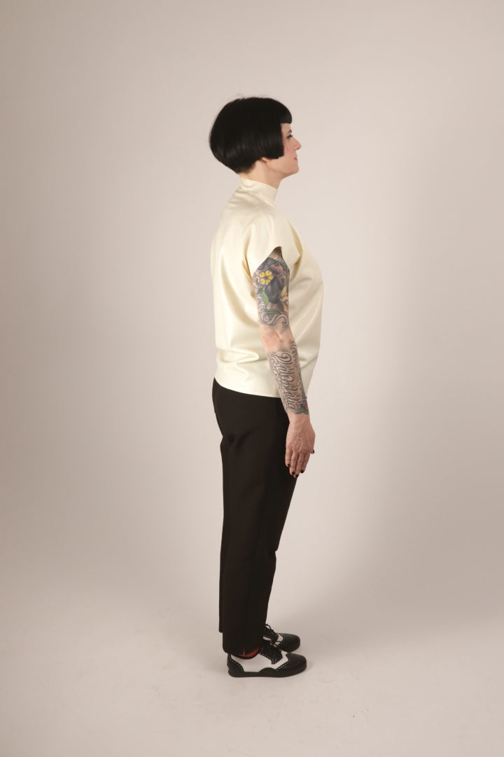 Side view of Anja in our white loose sleeveless 60s latex top.