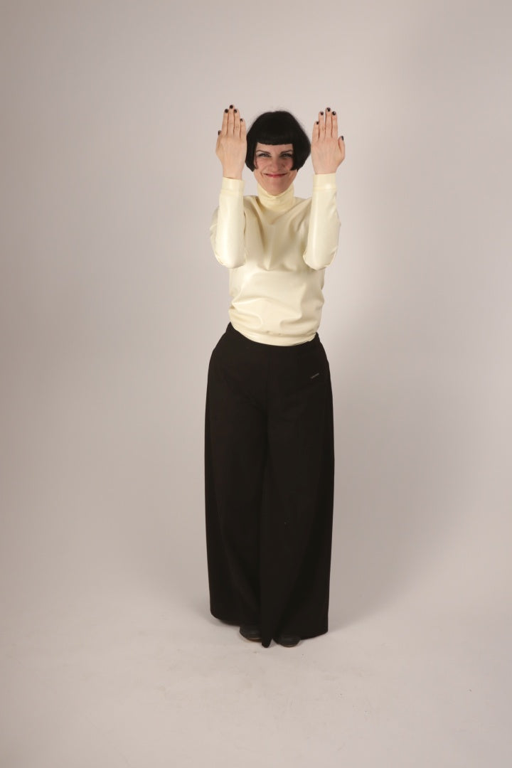 anja grinning and vogueing in our white latex turtleneck top