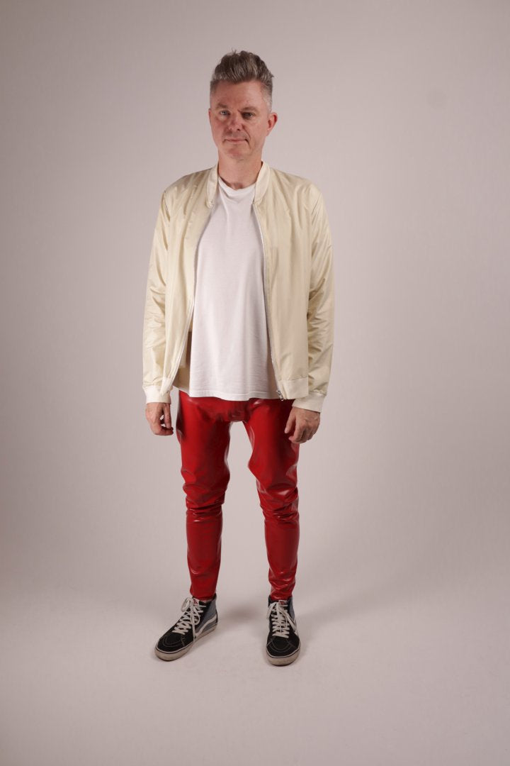 Our model Fabian in loose red glossy mens latex rubber leggings
