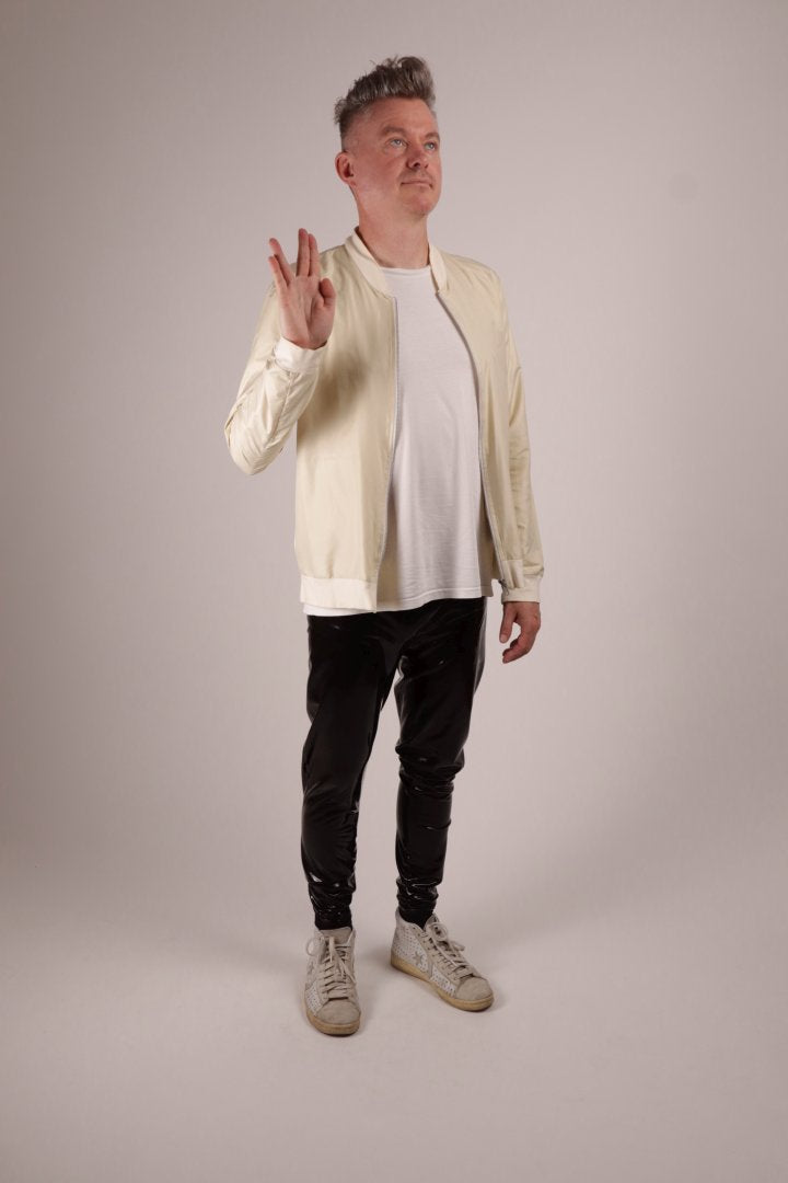 Our model Fabian in loose black glossy mens latex rubber leggings doing the vulcanian 'live long and prosper' sign