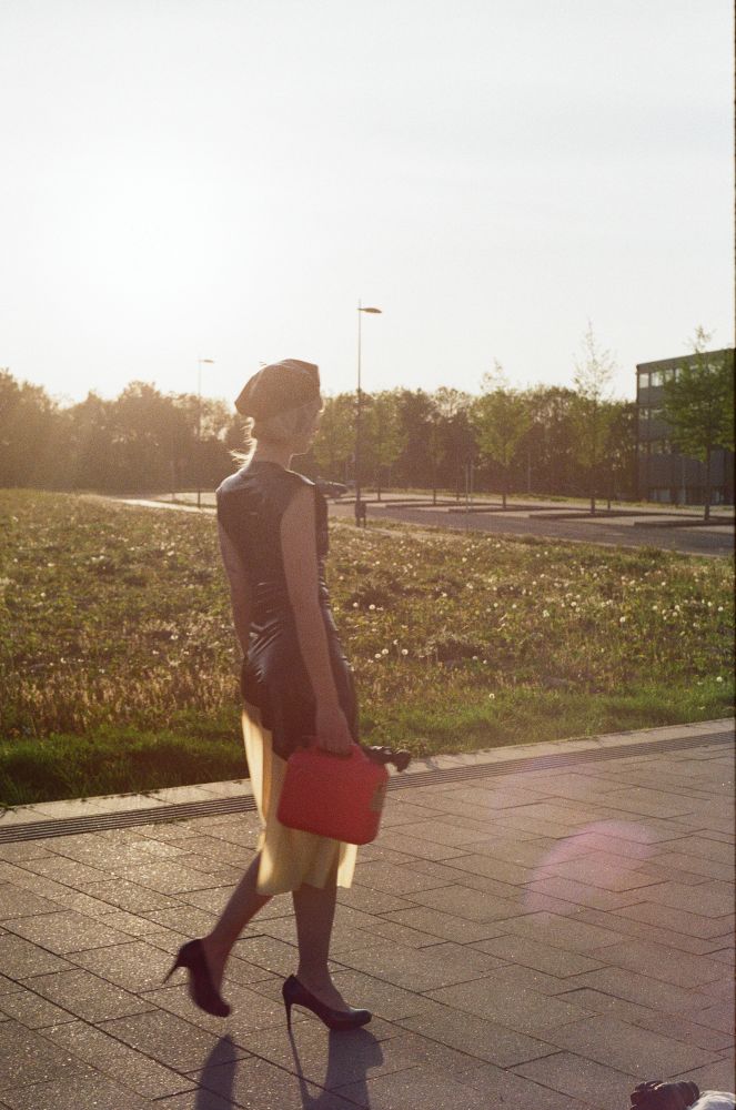 half-transparent-latex-midi-skirt-combined-with-black-top-and-gas-can