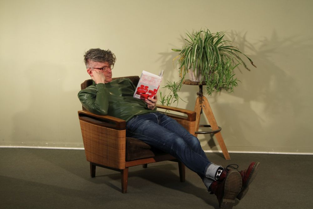 model-in-olive-green-latex-turtleneck-reading