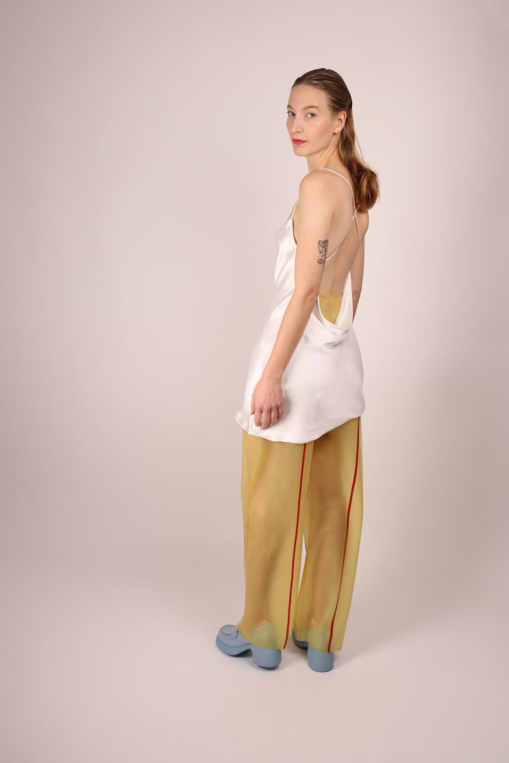 back-view-of-video-of-model-in-transparent-latex-sailor-pants-and-white-dress-shirt
