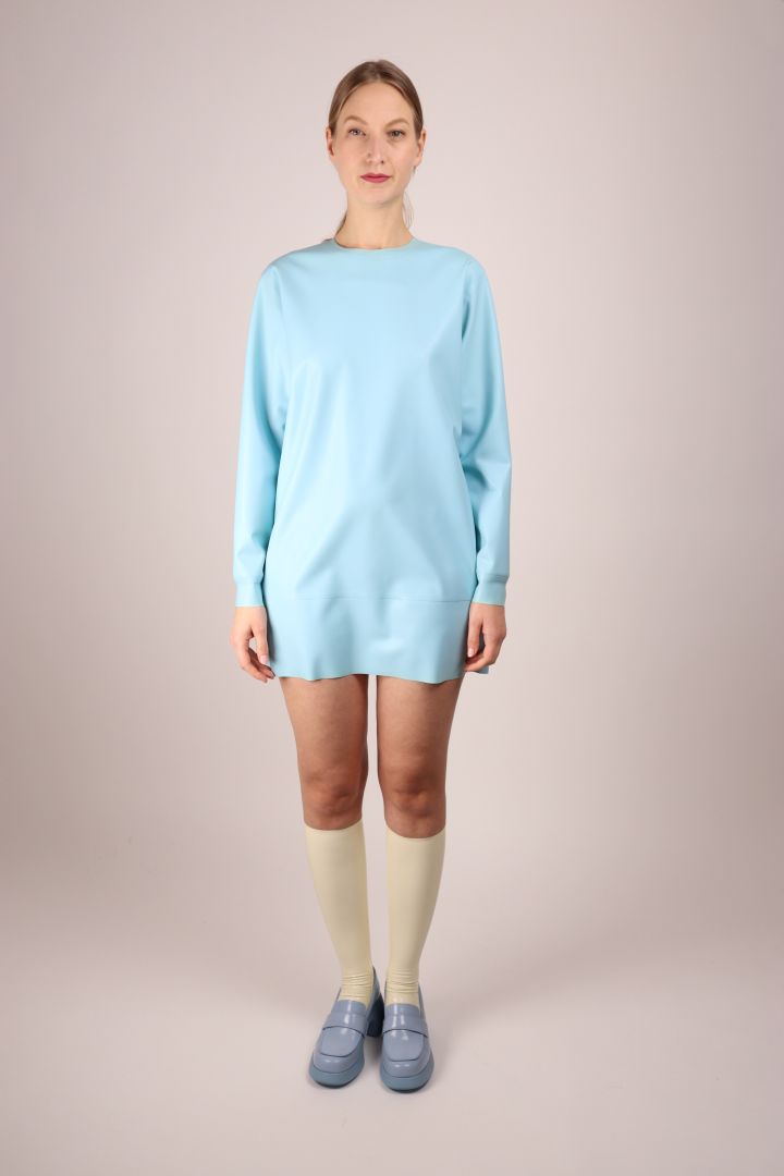 model in baby blue sweatshirt dress and matching camper shoes, frontal view