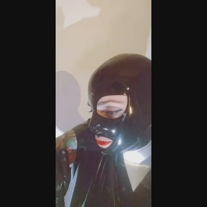 Our model Anja doing a little slow motion performance. She is wearing a black latex mask with a matching loose top, long gloves, and a silver latex high shirt collar a bit like the ones Karl Lagerfeld used to wear. Not so tall, not so stiff, but similar.