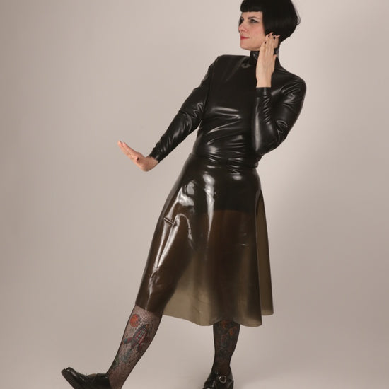 model Anja von Abels presenting her black latex turtleneck and her transparent black A-line skirt combined with fishnets and creepers.