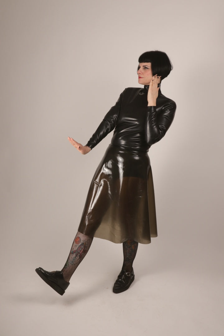 model Anja von Abels presenting her black latex turtleneck and her transparent black A-line skirt combined with fishnets and creepers.