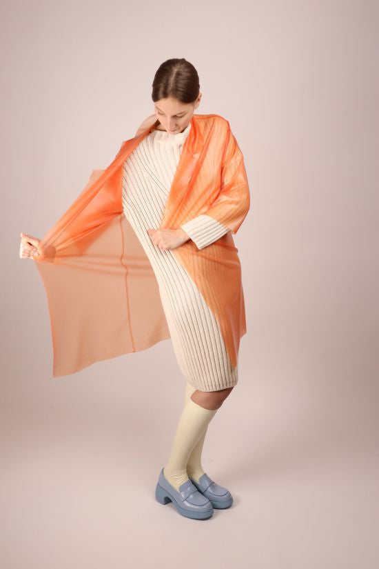 model-stretching-salmon-latex-trench-coat