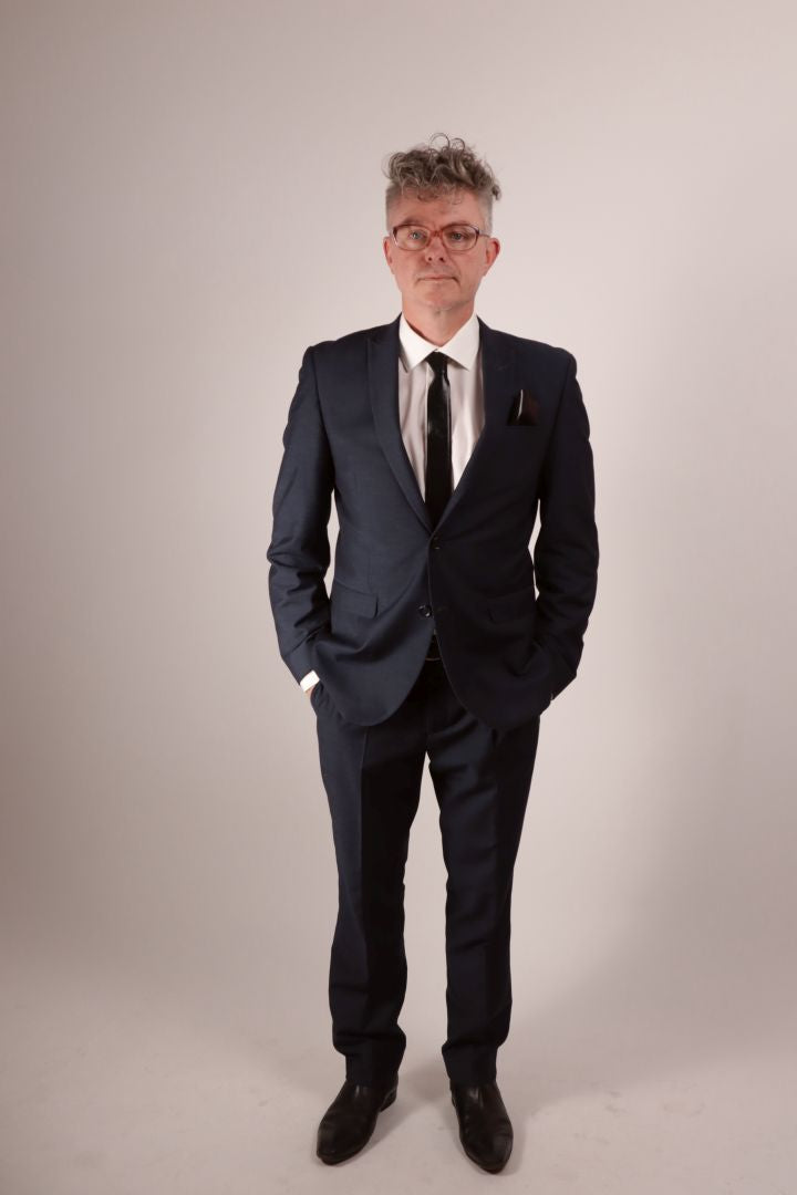 Total of our model in his navy blue business suit and white dress shirt and his black narrow latex neck tie with matching latex pocket square.
