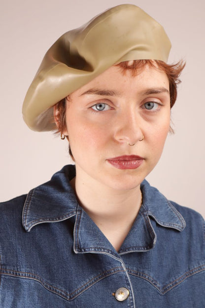 Annabel wearing our sand beige colored latex beret cocked sideways