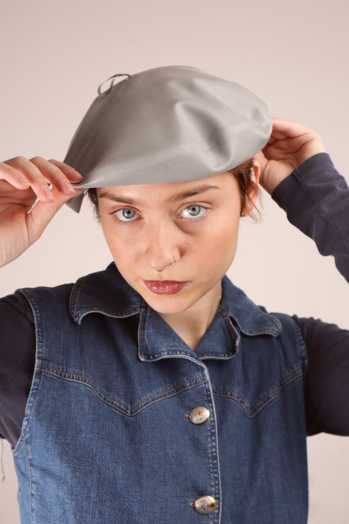 Annabel putting on our two-sided grey and black latex beret 