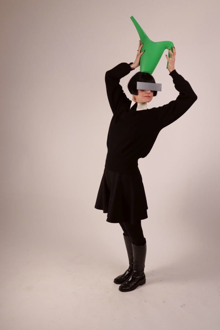 Anja sporting our warm white latex collar with press studs. She is wearing it over a black woolen sweater and with a black midi skirt and leather boots, and incognito sunglasses.