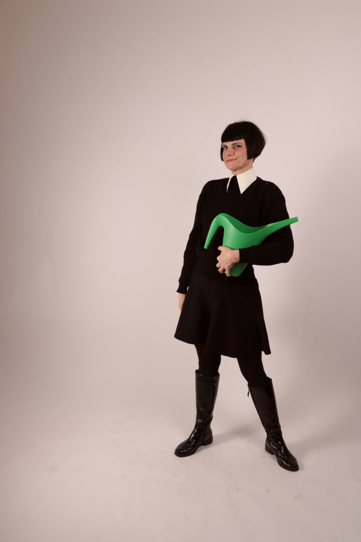 Anja sporting our warm white latex collar with press studs. She is wearing it over a black woolen sweater and with a black midi skirt and leather boots.