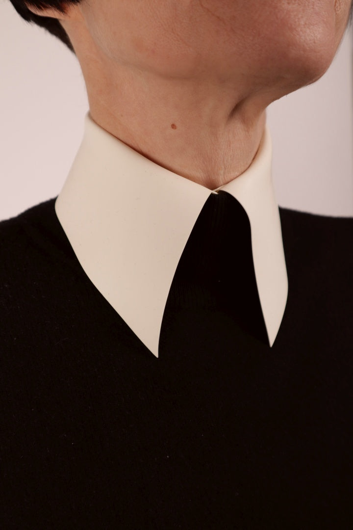close-up of a warm white latex collar with press studs and a bit like the ones Karl Lagerfeld used to wear