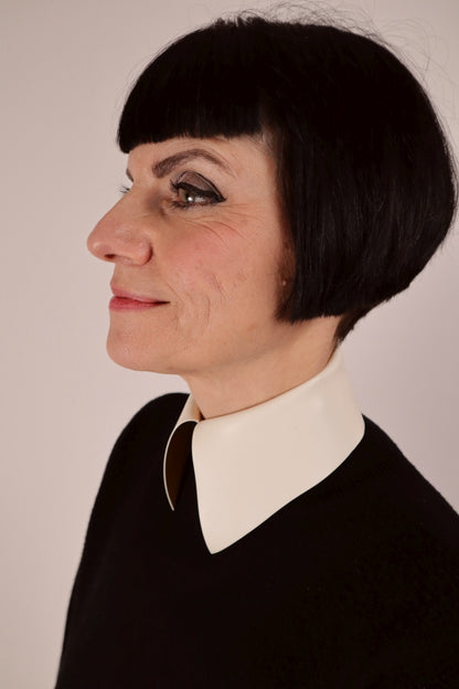 close-up of a warm white latex collar with press studs and a bit like the ones Karl Lagerfeld used to wear