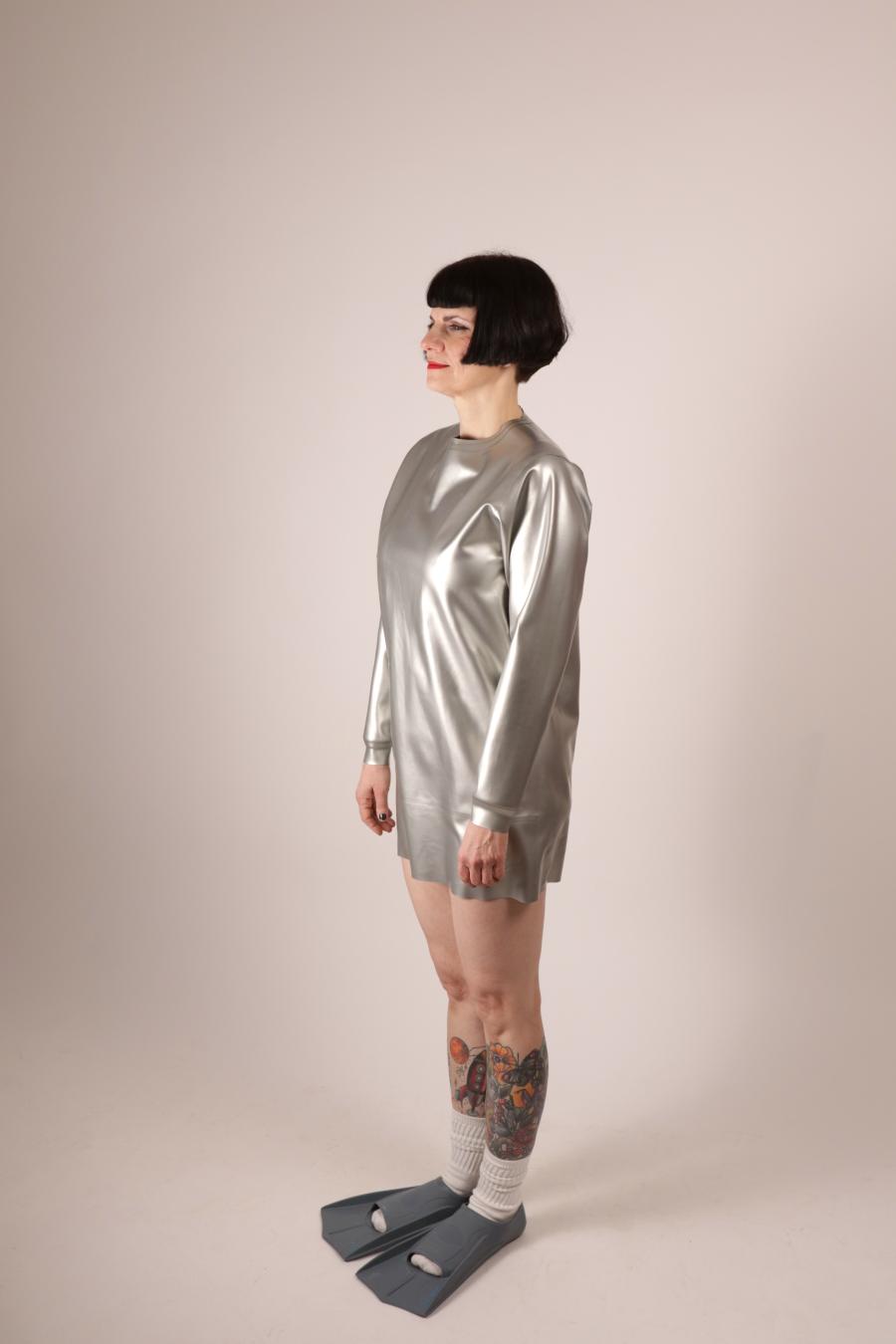 side view of Anja Abels in a silver latex sweatshirt dress