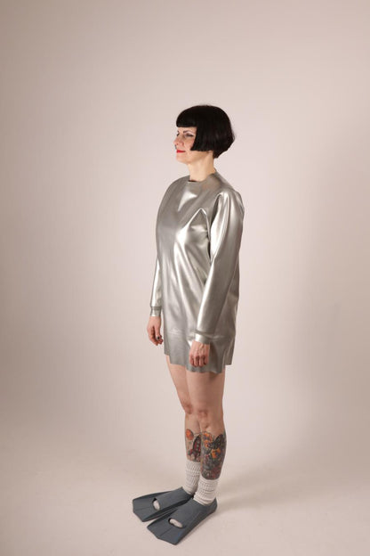 side view of Anja Abels in a silver latex sweatshirt dress