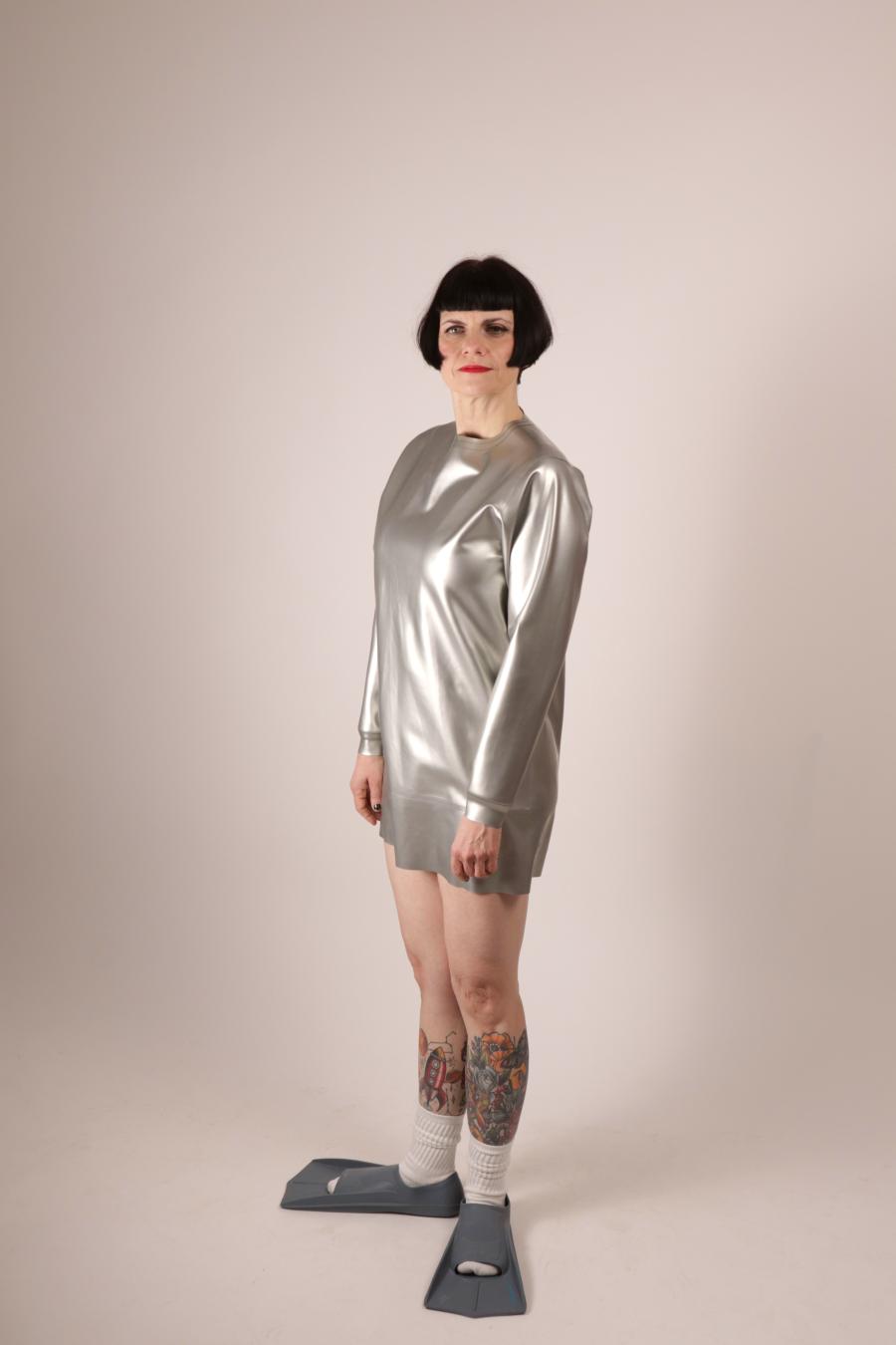 side view of Anja Abels in a silver latex sweatshirt dress