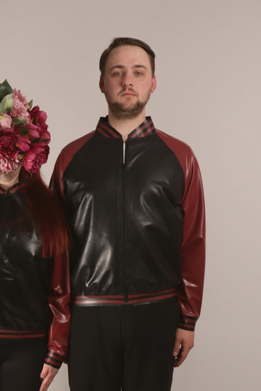 Close-up of Paul in a black and maroon latex college jacket. The Amercians call it varsity jacket, don't they.