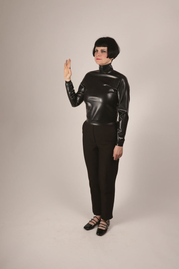 Our model Anja doing a vulcanian v greet in a black latex turtleneck sweater top and business pants.