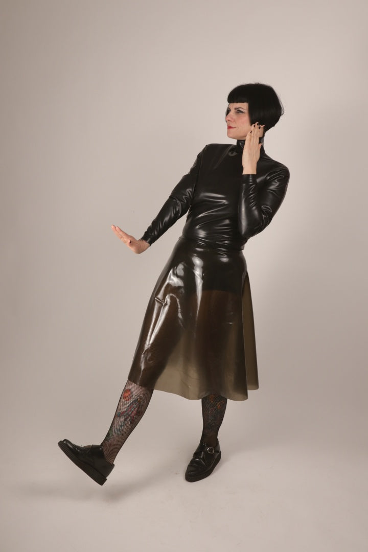 our model anja in a transparent-black latex midi skirt and a black turtleneck