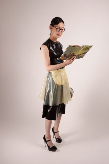 Hani reading a 70s vegetarian cook book. A fashionista in our TARZA & JANE impossible latex maid dress. 