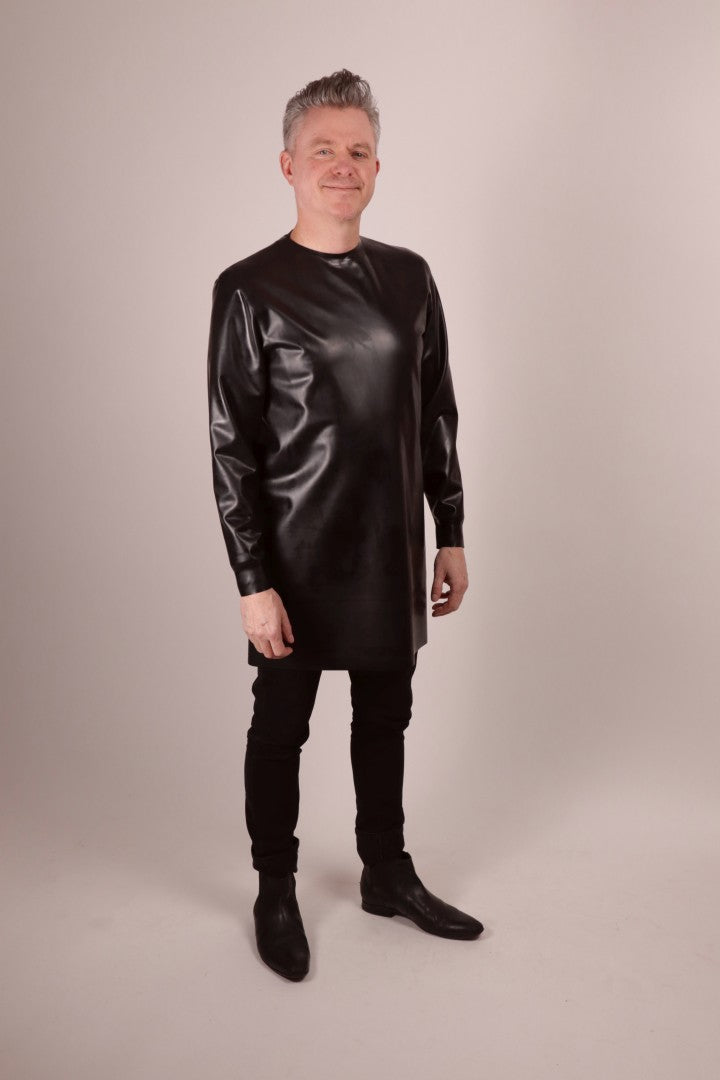 our model Fabian grinning into the camera and wearing a black latex long sweatshirt.