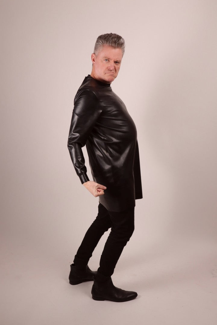 our model Fabian doing a 'Yesss! Tchakka!'  move in his black latex long sweatshirt, black jeans and pointy shoes.