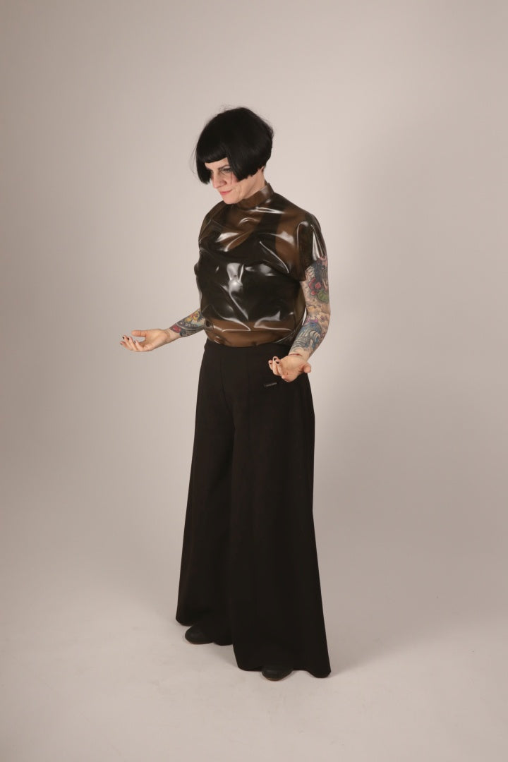 Anja in her transparent-black sleeveless latex 60s top by TARZA & JANE, and black sailor pants.