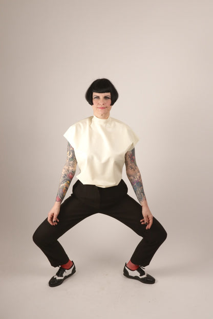 Anja doing a ballet move in her white sleeveless latex top by TARZA & JANE.