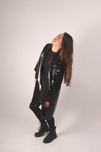 christina in the middle of a dance move in our black latex trenchcoat that is a bit oversize and extra chic this way