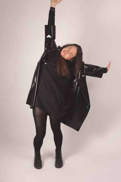 christina dancing in her feel-good black latex coat.
