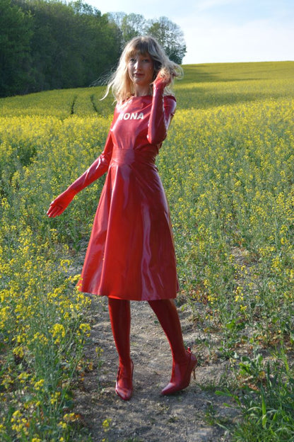 mona in red latex midi skirt in rapeseed fields