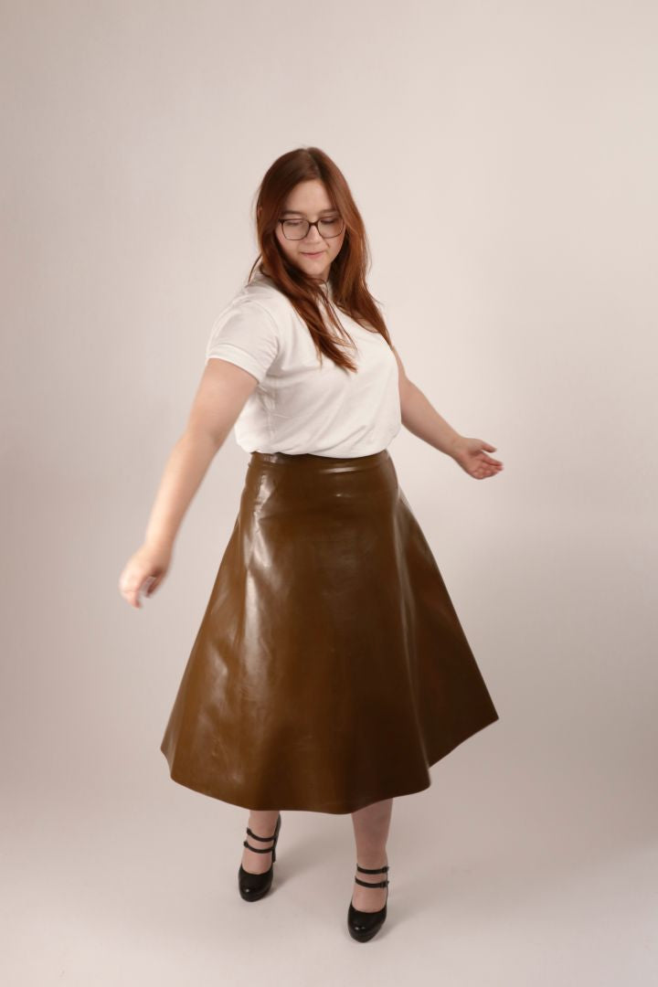 model spinning chocolate brown latex a-line midi skirt