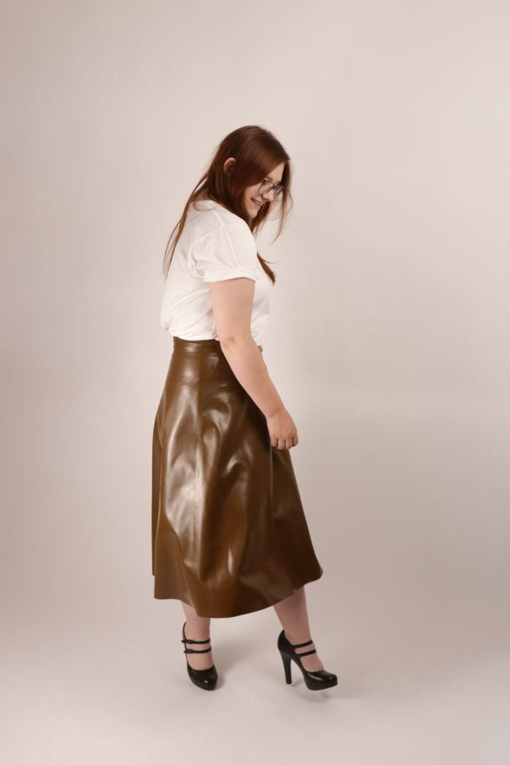 girl spinning brown latex a-line midi skirt