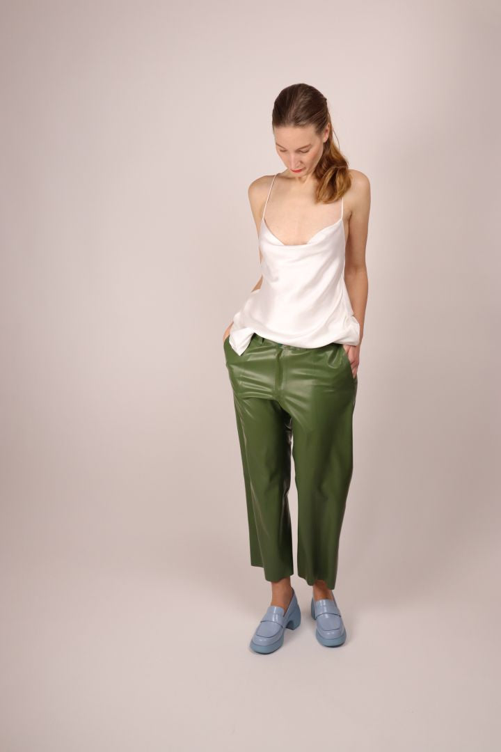 hands-in-pockets-of-green-ladies-latex-flat-front-pants