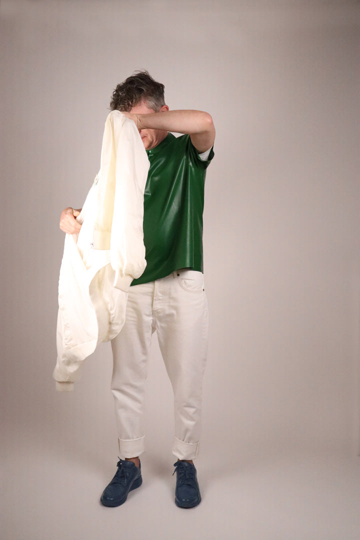 fabian-putting-on-his-white-bomber-jacket-over-green-latex-poloshirt